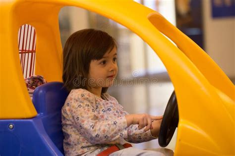 Cute Little Girl In The Little Toy Car Trolley At Supermarket Stock