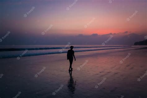 Premium Photo Silhouette Man Walking On The Beach At Sunset
