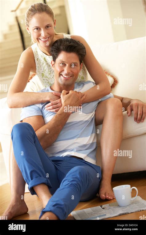 Couple Relaxing On Sofa At Home Stock Photo Alamy