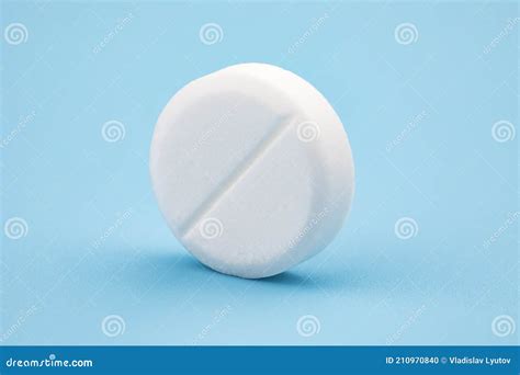 White Round Pill on Blue Background. Health Care Concept Stock Photo