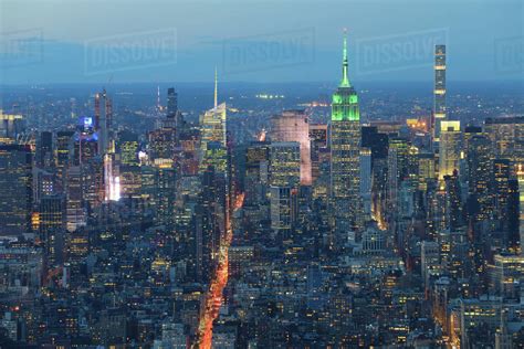 View of Midtown Manhattan skyline at night - Stock Photo - Dissolve