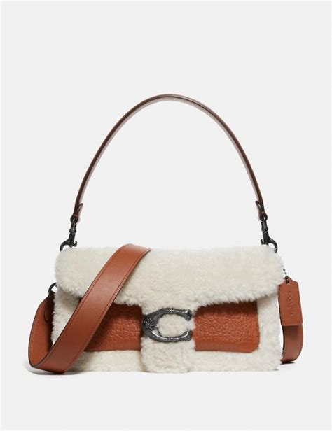 A modern take on an archival 1970s coach design, our structured tabby shoulder bag is crafted in a mix of refined leather and sophisticated tweed bouclé. COACH: Tabby Shoulder Bag 26