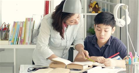 Cute Asian Mother Helping Your Son Doing Your Homework Stock Image