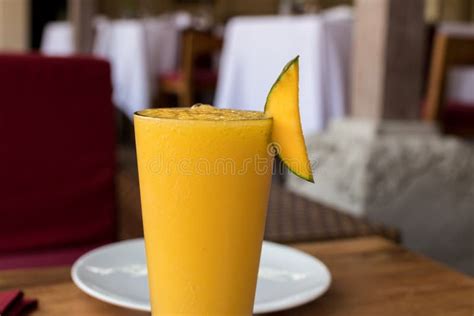 Refreshing Glass Of Tropical Mango Juice On A Wooden Table Bali Island