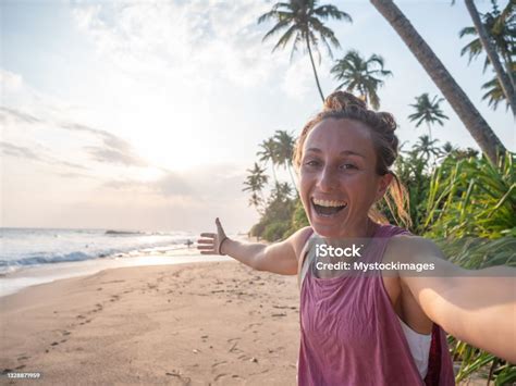 Young Woman Taking Mobile Phone Selfie On Tropical Beach At Sunset