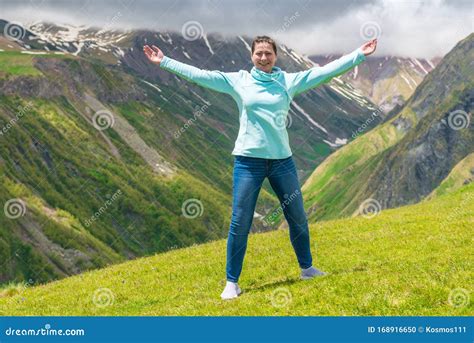 Portrait Of A Beautiful Happy Woman With Arms Outstretched Stock Photo