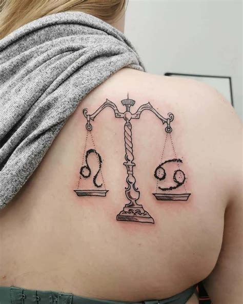 A Woman With A Tattoo On Her Back Has An Libra Symbol Tattooed On Her Shoulder