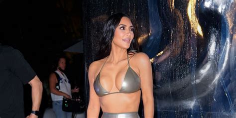 kim kardashian takes an outdoor shower in a black thong bikini