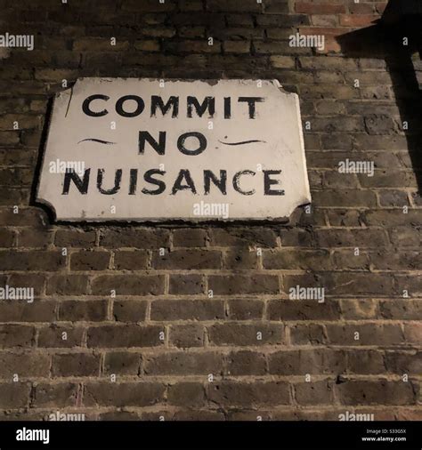 Victorian Sign On Brick Wall In London At Night Warning Against