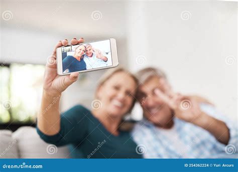 Peace Out An Affectionate Mature Couple Taking Selfies Together While