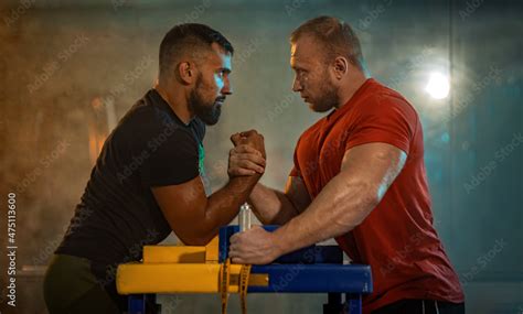 The Armwrestling Two Strong Athletes In The Gym Compete In Arm