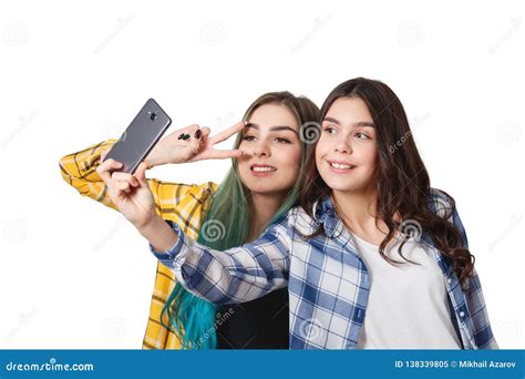 Two Girls Friends Taking Selfie With Smartphone Isolated On White Background Stock Image
