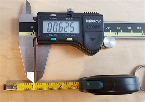 You can not measure to that kind of absolute accuracy with the tape wandering all over the place. Double-Checking My Anvil Tape Measure's Marking Widths