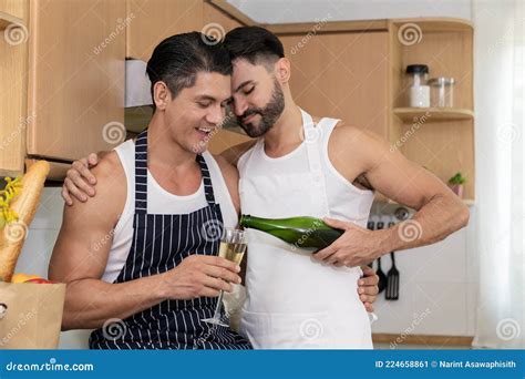 Joyful Gay Couple Celebrating Pride Month With Champagne In Kitchen Stock Image Image Of Males