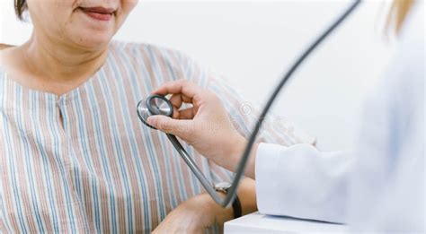 Young Doctor Using Stethoscope To Exam Senior Patient Heart Stock Photo