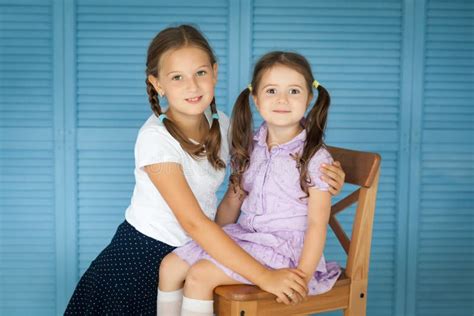 School Girl In A Uniform And Her Sister Pre School Kid Stock Photo