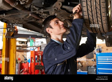 Trainee Mechanic Working Under Car Stock Photo Alamy