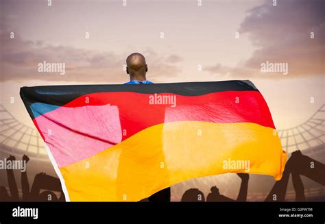 Composite Image Of Rear View Of Sportsman Is Holding A German Flag