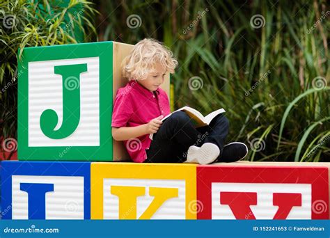 Child Reading Book Kid Learning Letters Stock Image Image Of Blond