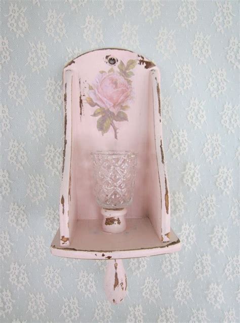 A Pink Shelf With A Glass Vase On The Top And A Flower Painted On It