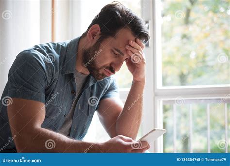 Sad Man Holding Phone Alone At Home Stock Photo Image Of Conflict Person