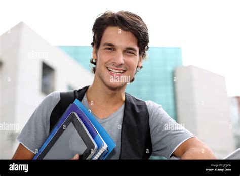 Cheerful Student Standing Outside College Building Stock Photo Alamy