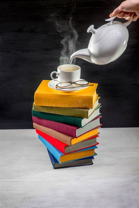 Stack Of Colorful Books With A Cup Of Tea On It And Teapot Stock Image