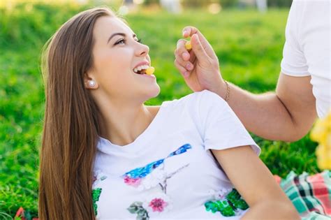 Premium Photo Cheerful Young Girl Eats Grapes Lies On The Grass The