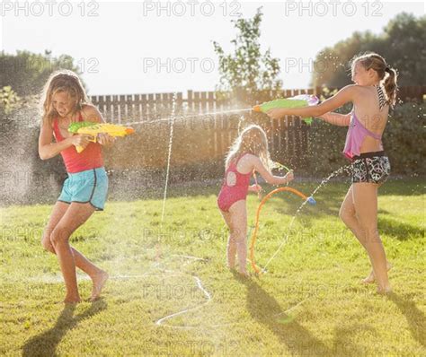 caucasian girls shooting water guns photo12 tetra images mike kemp