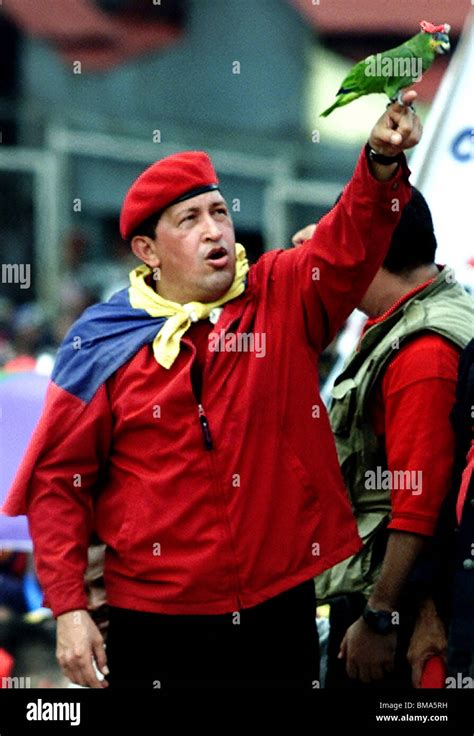 Venezuelas President Hugo Chavez Holds Up A Parrot Wearing His Iconic