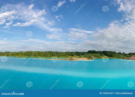 Panorama Of A Beautiful Lake With Azure Blue Water Green Trees Blue
