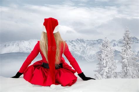 Beautiful Blonde Woman Wearing A Red Dress And A Santa`s Hat In