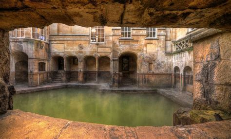 An Old Building With A Pool In The Middle