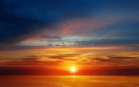 Rainbow Colorful Sunset On Blue Pink Sky Yellow Clouds Skyline Water