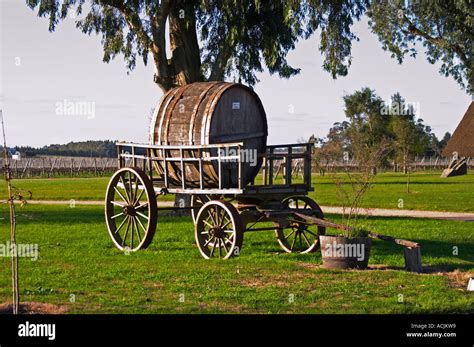 An Old Horse Drawn Carriage Cart With An Old Wooden Barrel In The