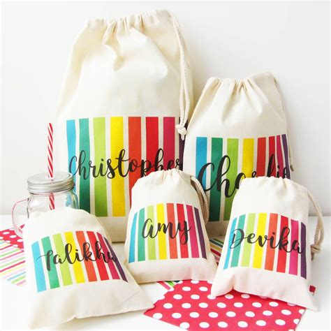 Three Personalized Drawstring Bags With Polka Dots And Rainbow Stripes