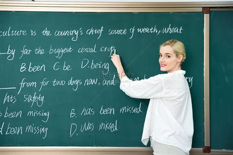 Foreign Teacher Writing A Question On The Blackboard Picture And Hd