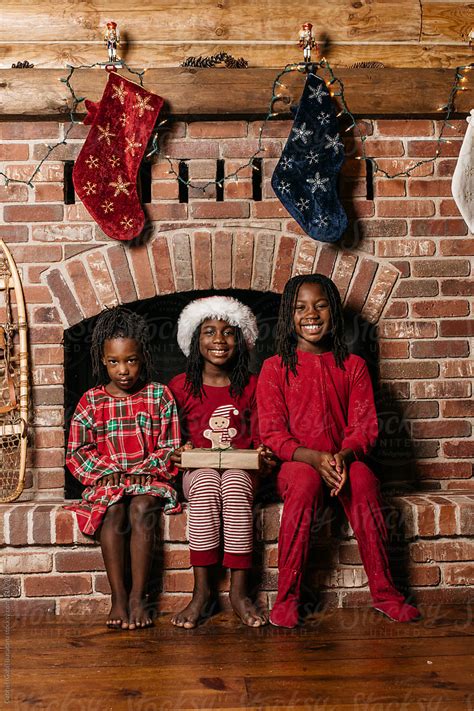 happy blacl sisters wearing christmas themed pajamas by stocksy contributor gabi bucataru
