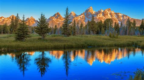 Landscape View Of Mountain And Trees With Reflection On River In Grand