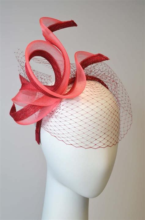 this fascinator has a fanciful shape and looks great with every outfit the alice band is coverd