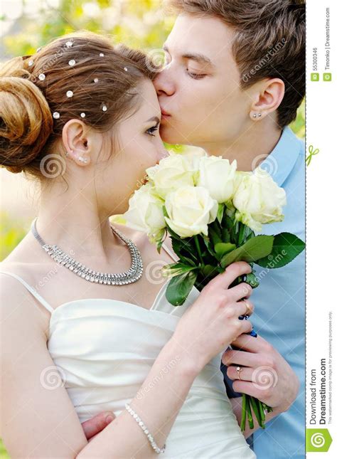 Groom Kisses The Bride On Walk On Their Wedding Day Stock Photo Image