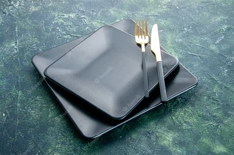 Free Photo Front View Black Square Plates With Golden Fork And Knife
