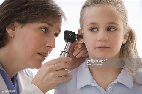 Female Doctor Using Otoscope To Examine Girls Ear Closeup High Res