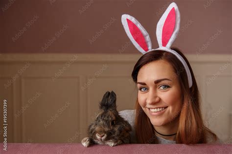 Happy Easter Funny Girl Wearing Bunny Ears And Holding Easter Rabbit