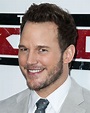 Chris Pratt jokes with photographers as he hunks out in grey suit at ...