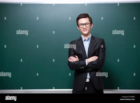 Professional Male Teacher Arms Crossed In Classroom Stock Photo Alamy