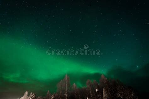 The Northern Lights Aurora Borealis At Kuukiuru Village Lake In Lapland