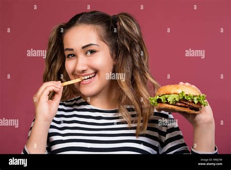 Teen girl and cheeseburger hi-res stock photography and images - Alamy