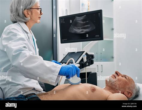 Heart Ultrasound Exam For Senior Man With Ultrasound Specialist While