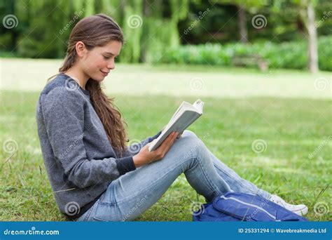 Young Relaxed Girl Reading A Book While Sitting Stock Photo Image Of